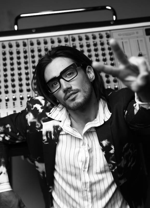 Man in a recording studio wearing rectangular Vinylize Kaufmann glasses