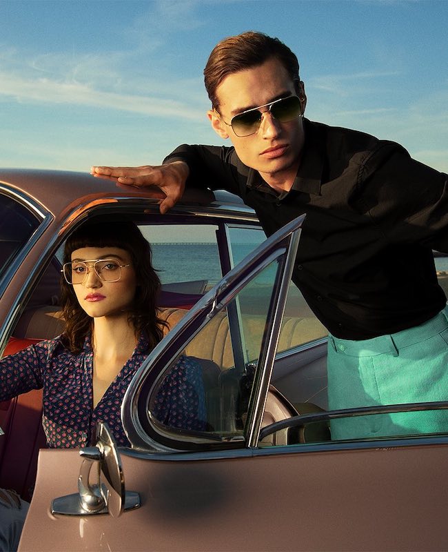 Two people in a vintage car wearing Dita aviator glasses and sunglasses